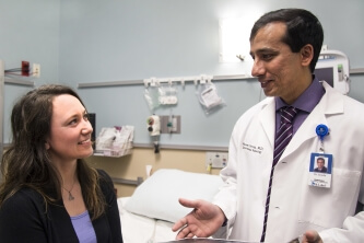 Dr. Naveen Gowda, St. Luke's interventional radiologist, talks with his patient Britt Johnson
